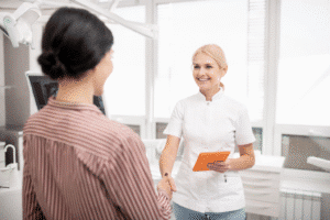 Calm, modern dental clinic with friendly dentist reassuring patient.